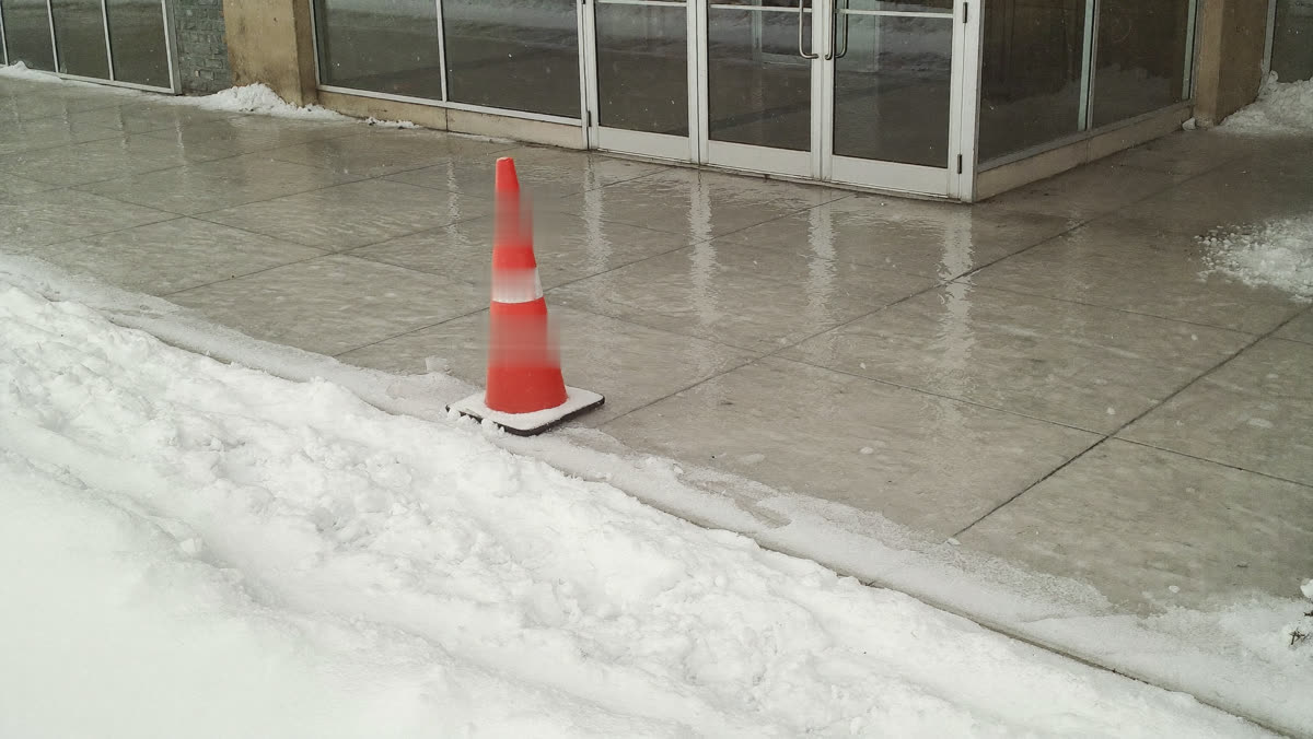 Icy commercial walkway in Edmonton during a winter parking ban